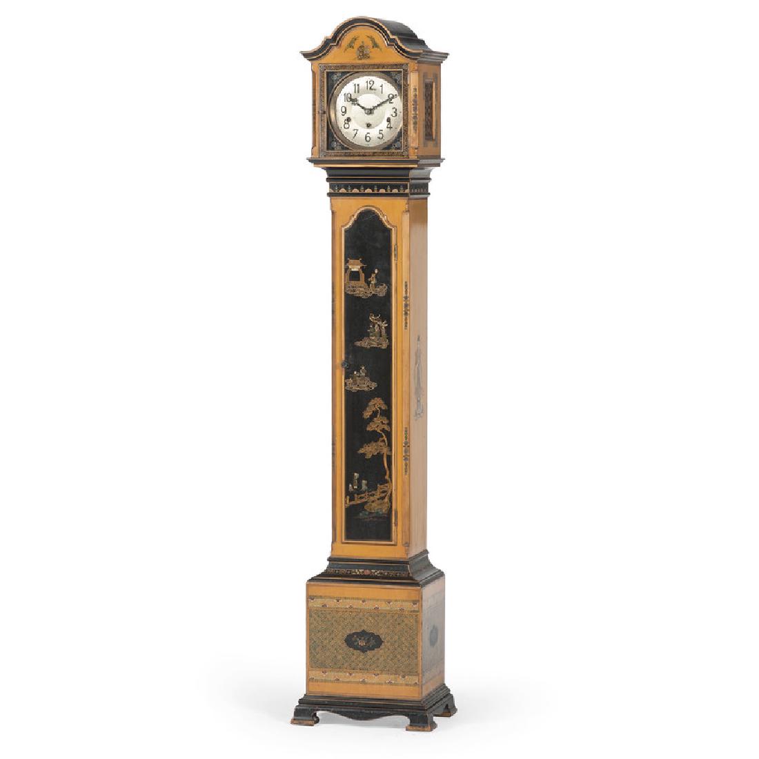 Japanned Grandmother Clock with Kienzle Westminster: German, 20th century. A japanned grandmother clock in lacquered wood, the removable bonnet top having an arched pediment with single hinged door, enclosing a metal face and Kienzle works, over a lacqu