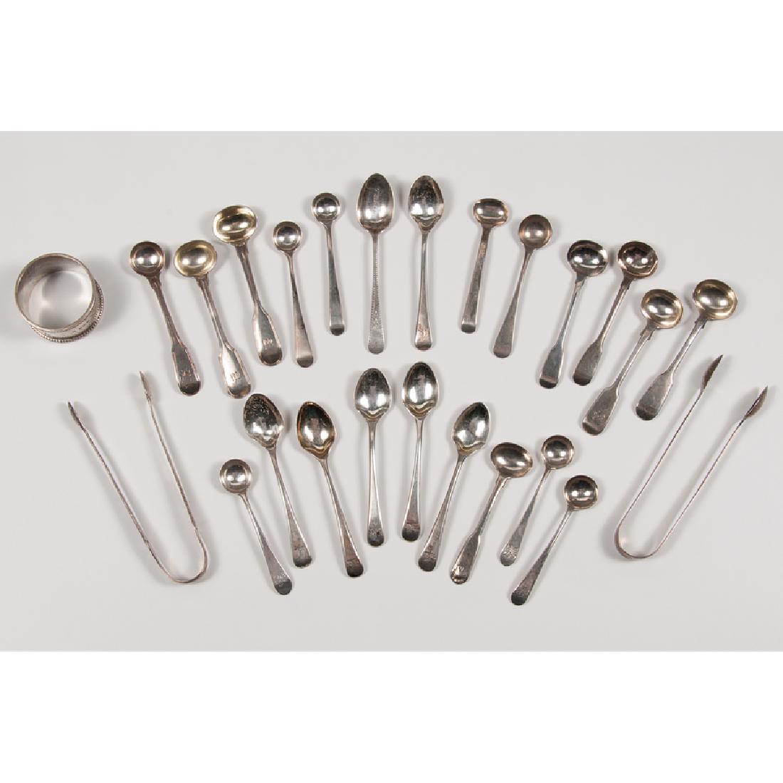 British Sterling Spoons and Sugar Tongs, Plus: British, 18th-19th century. Twenty-two sterling silver pieces, including coffee, salt, and mustard spoons and two pairs of sugar tongs, all by various makers; PLUS one sterling napkin ring; longest lg