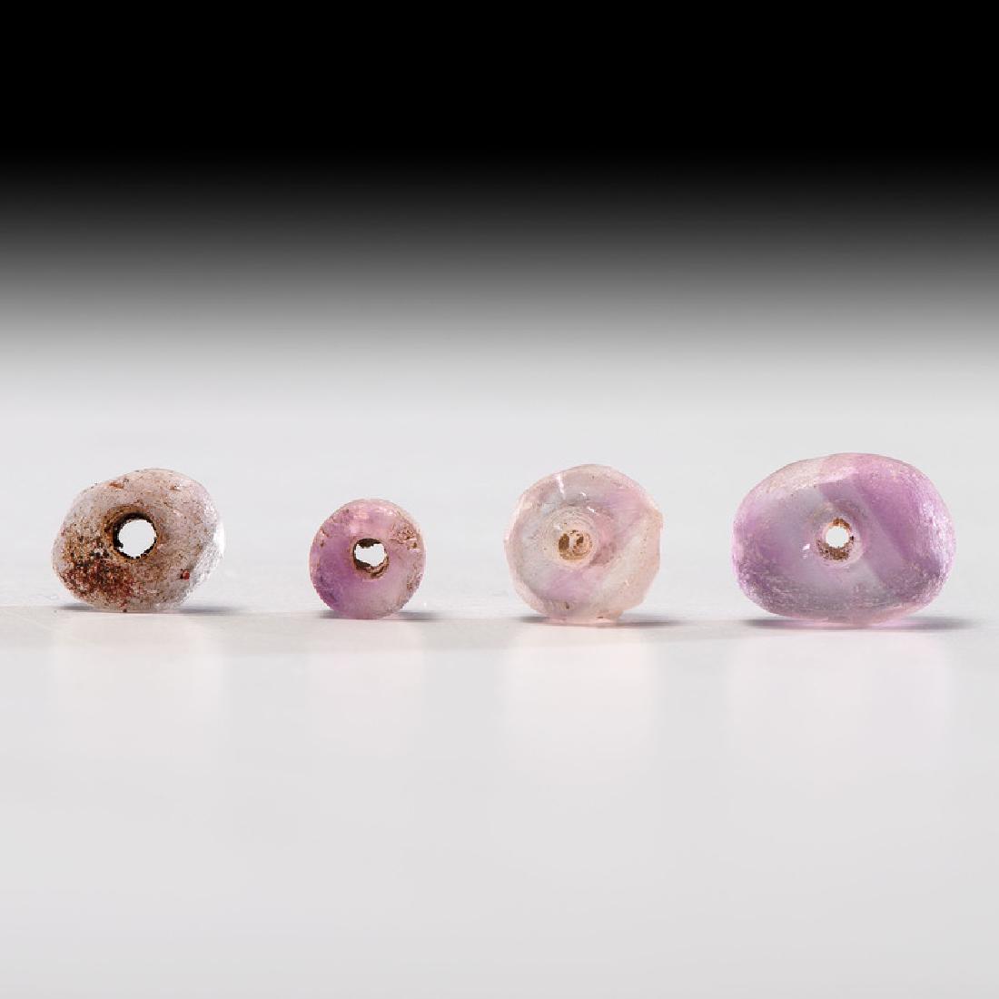 Four Lavender Fluorite Disc / Donut Beads; Largest 1/2: Mississippian Culture, Late Prehistoric Period, A.D. 1000-1500 lot of 4, largest diameter 1/2 in. Provenance: Collection History: From the exceptional Gerber fluorite collection. Published: Gerber, Ar