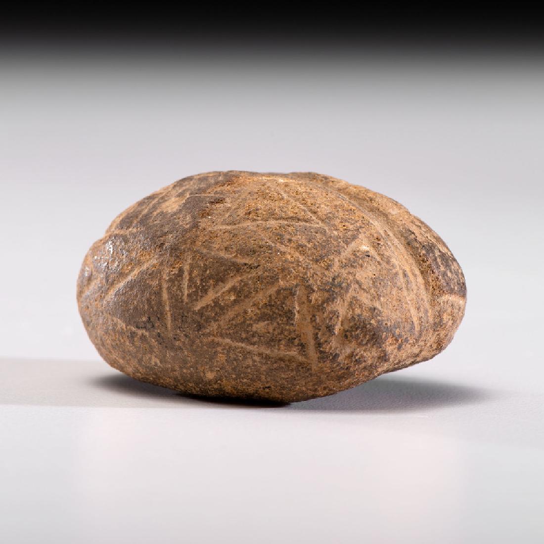 An Engraved AND Grooved Loafstone, 2-1/4 in.: Adena Culture, Early Woodland Period, 800 B.C. - A.D. 1 length 2-1/4 in. Provenance: Published: Gerber, Art, The Art Gerber Story, 2007, pg. 313, fig. 7.253