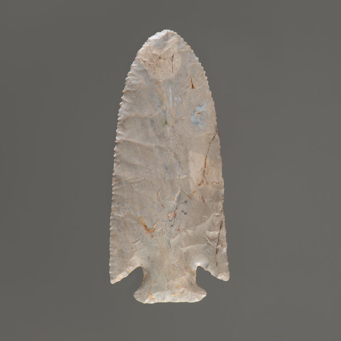 A Hardin Point, 4-1/4 in.: Early Archaic Period, 10,000-8000 B.C. Expertly restored base and one ear. length 4-1/4 in. Provenance: Collection History: Gerber Collection Number: AG.53 Published: Gerber, Art, The Art Gerber Story