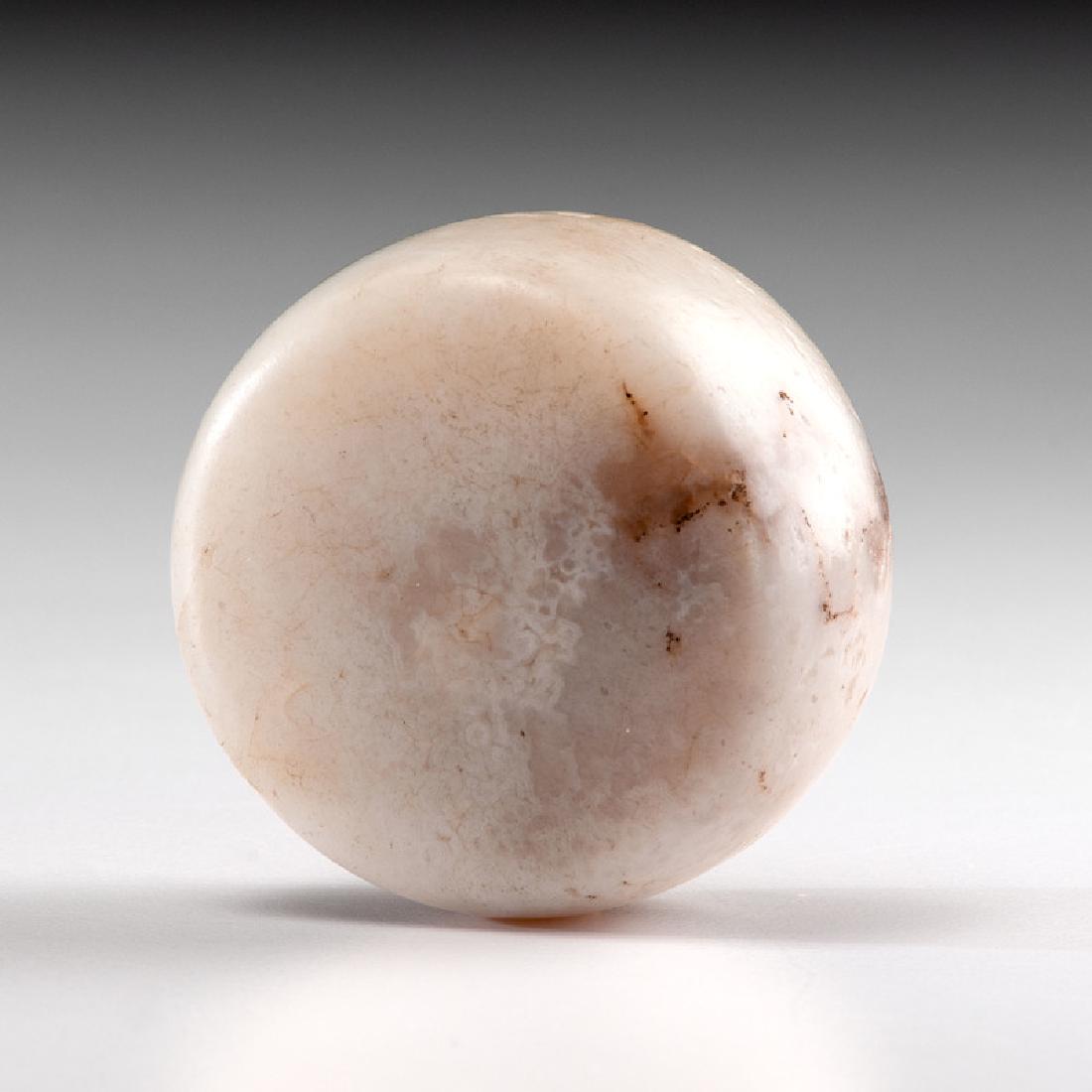 A White Quartz Biscuit Discoidal, 2 in.: Mississippian Culture, Late Prehistoric Period, A.D. 1000-1500 diameter 2 in. Provenance: Published: Gerber, Art, The Art Gerber Story, 2007, pg. 186, f. 7.126