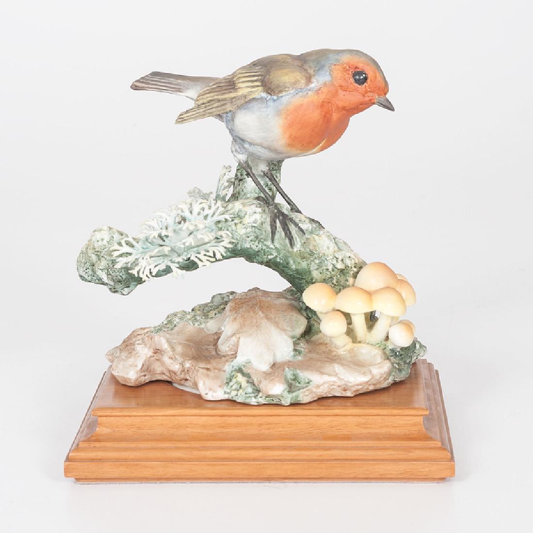 Royal Worcester Dorothy Doughty Robin: English, second half 20th century. A painted porcelain English robin figure, perched in autumn woods, modeled by Dorothy Doughty (1892-1962) for her British Birds series, and produced by Royal Worcest