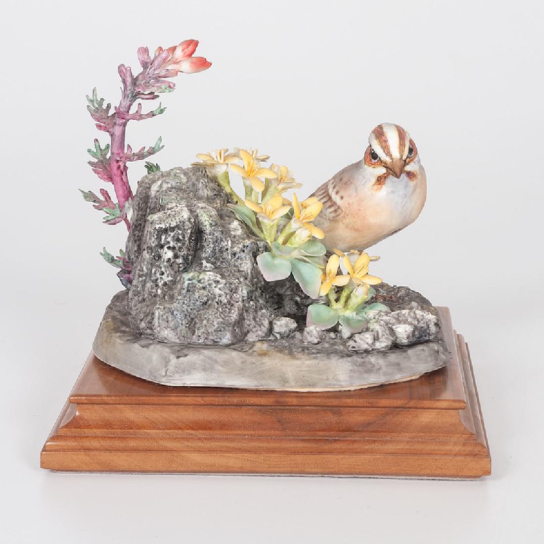 Royal Worcester Dorothy Doughty Lark Sparrow: English, first half 20th century. A porcelain lark sparrow perched on volcanic rock among red gilt and twinpod flowers, modeled by Dorothy Doughty (1892-1962) for her American Birds series, and produc