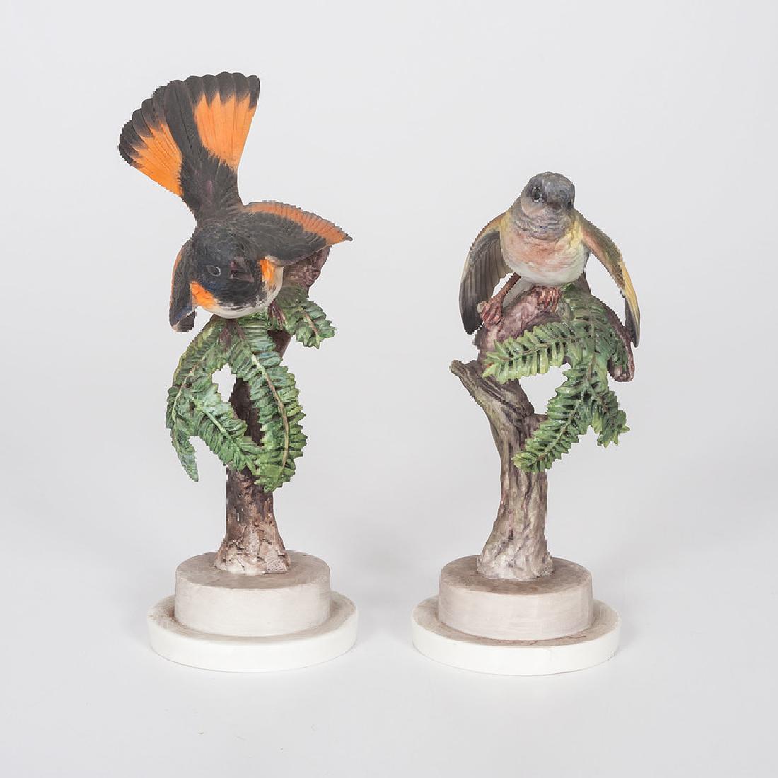 Royal Worcester Dorothy Doughty Redstarts figures: English, first half 20th century. A pair of painted porcelain redstarts, male and female, perched on hemlock branches, modeled by Dorothy Doughty (1892-1962) for her American Birds series, and produce