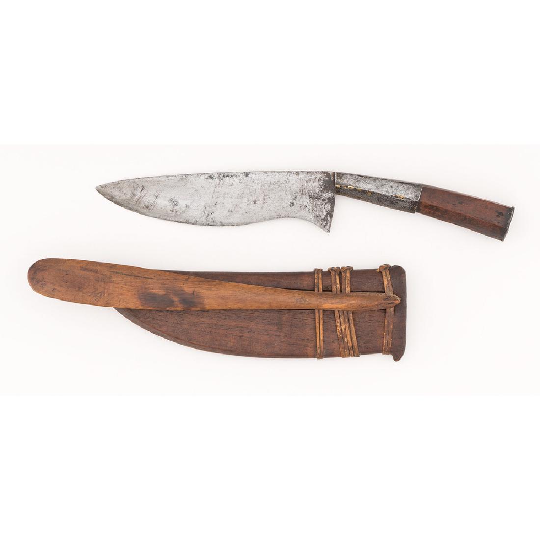 Indonesian Wedung Ceremonial Knife: wood handle; wood sheath with exaggerated belt hook, overall length 15.75 in. early 20th century