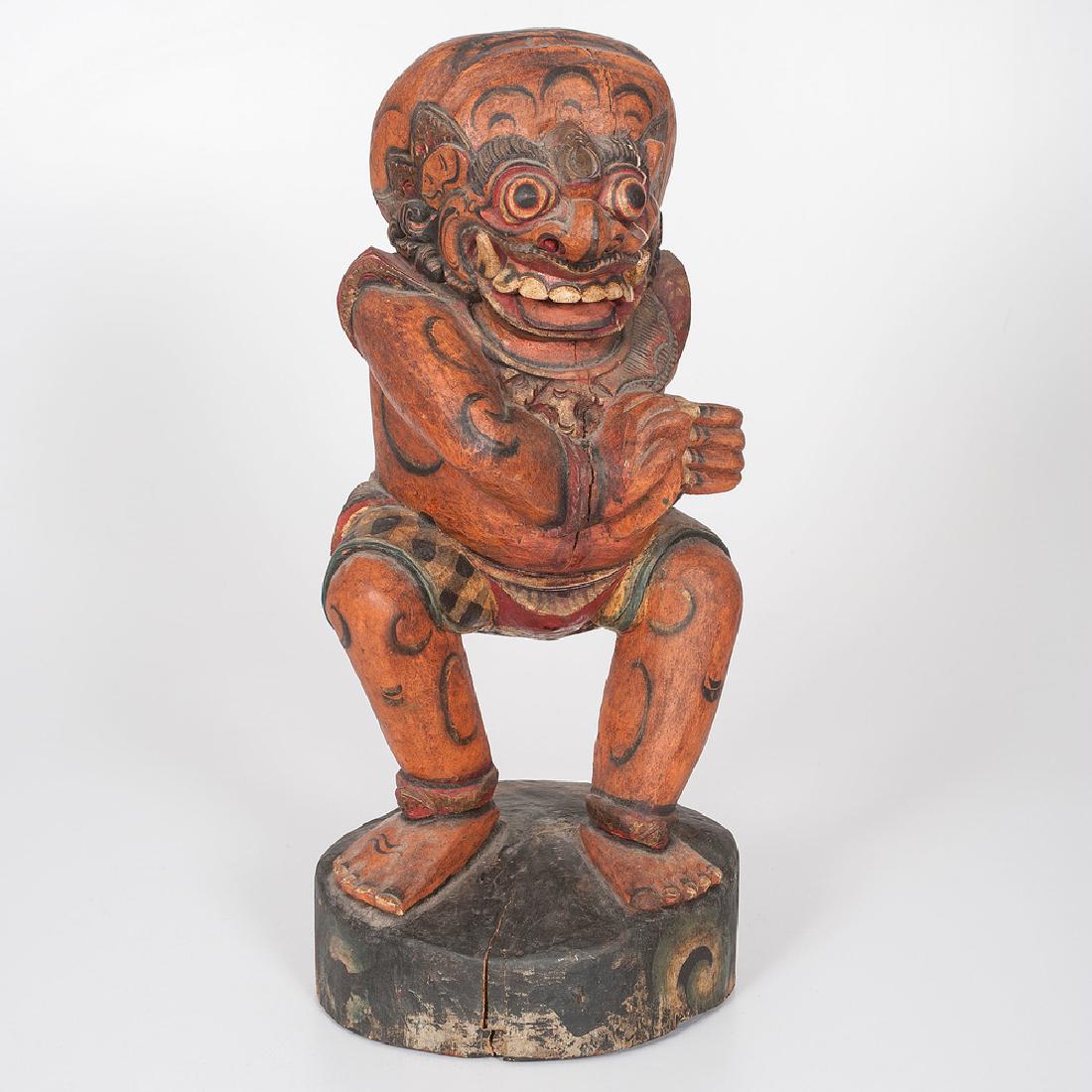 Carved Indonesian Kris Holder: 8" x 9" x 20". Polychrome wood carved in the likeness of a frightening figure with bared teeth, possibly a deity.
