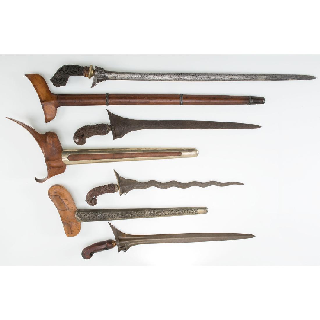 Four Indonesian Kris: lot of 4, three with sheaths, longest 25 in. late 19th - early 20th century