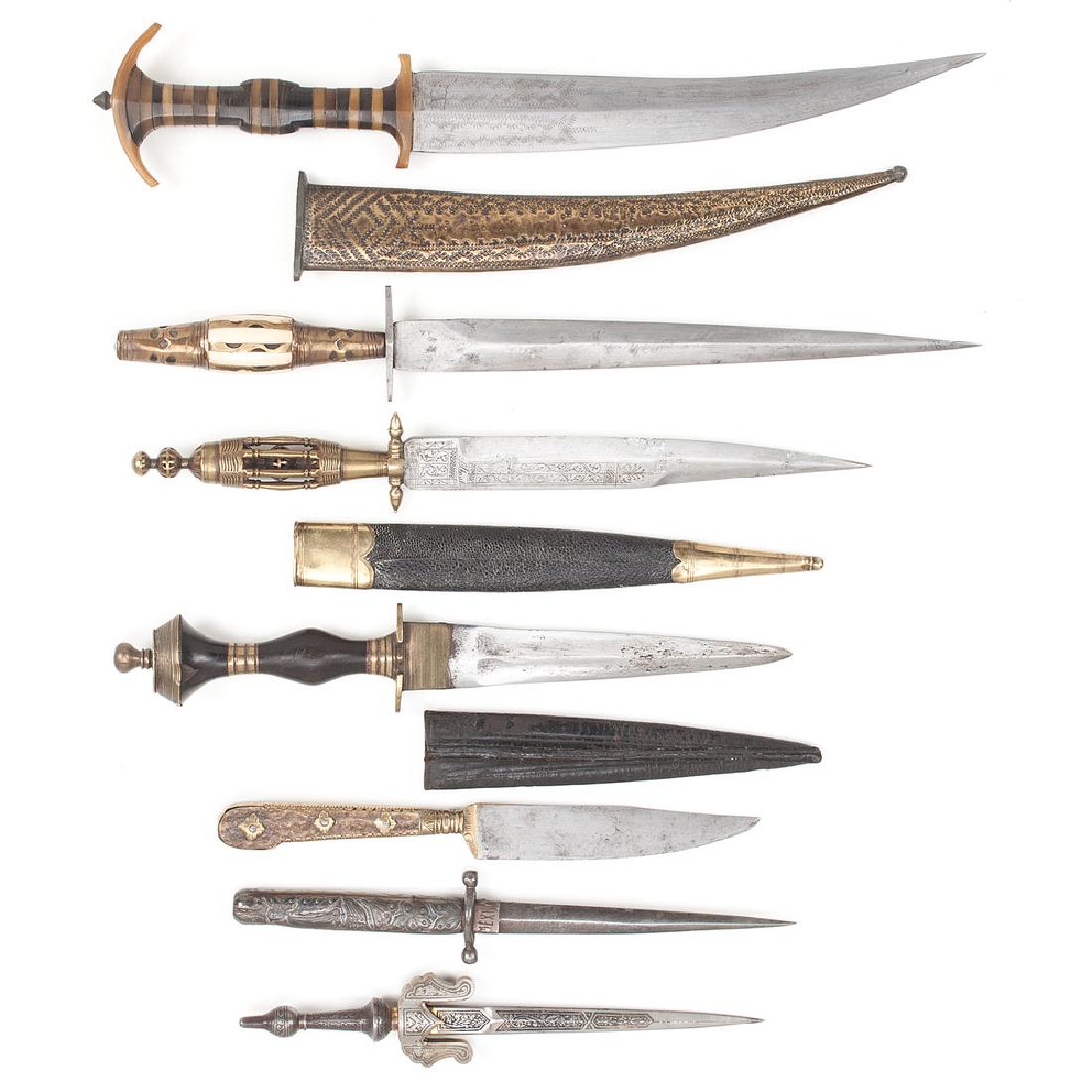 Lot of Seven European Knives: Lot consists of seven European knives of varying age. Blade lengths vary from to 5" to 5". Mounting materials include silver, bone, horn, antler, and brass. Some come complete with metal or leather sc