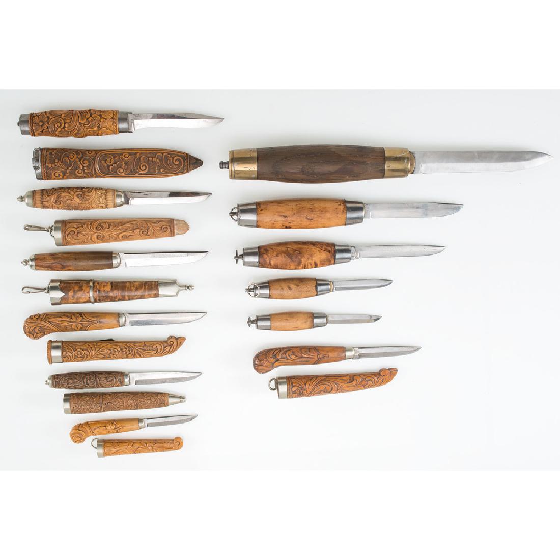 Lot of Twelve Swedish Knives: Lot consists of twelve Swedish folding and fixed blade knives with wood and brass grips. Blade lengths range from 2.5" to 5.5". Grips and scabbards heavily carved with detailed floral motifs.