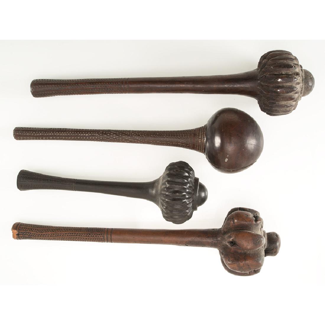 Fiji Carved Ironwood I-Ula Tatatava, Throwing Clubs: lot of 4, includes three having the head deeply carved with nesting serrations; handles further embellished with chip carving, lengths 17 in., 17.25 in., and 12 in.; AND another club with a simple bal