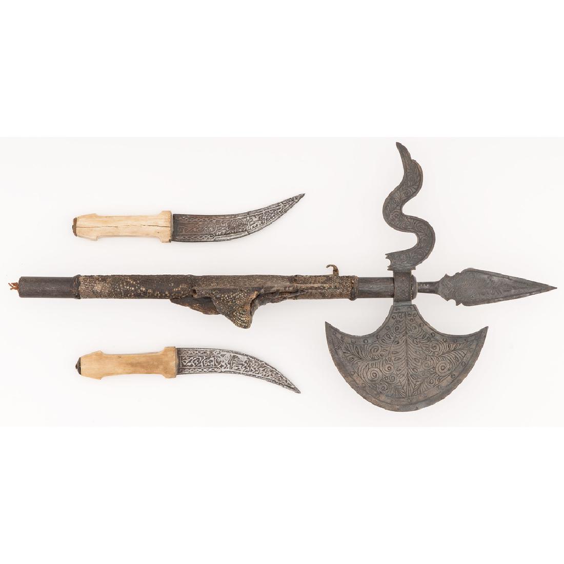 Sudanese Halberd Axe with Daggers and Reptilian Skin: design etched in axe blade; bone handled daggers, overall length 21.75 in. late 19th - early 20th century