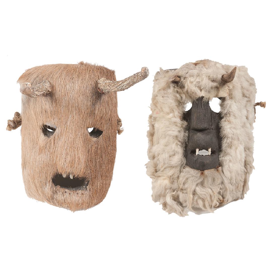 Mexican Zoomorphic Masks, Deaccessioned from the: lot of 2, includes a wooden goat mask with sheep fur accents, goat's horns and set with canine teeth, length 10 in. X width 8 in.; AND wooden deer mask with deer fur covering, deer antlers, and set wi