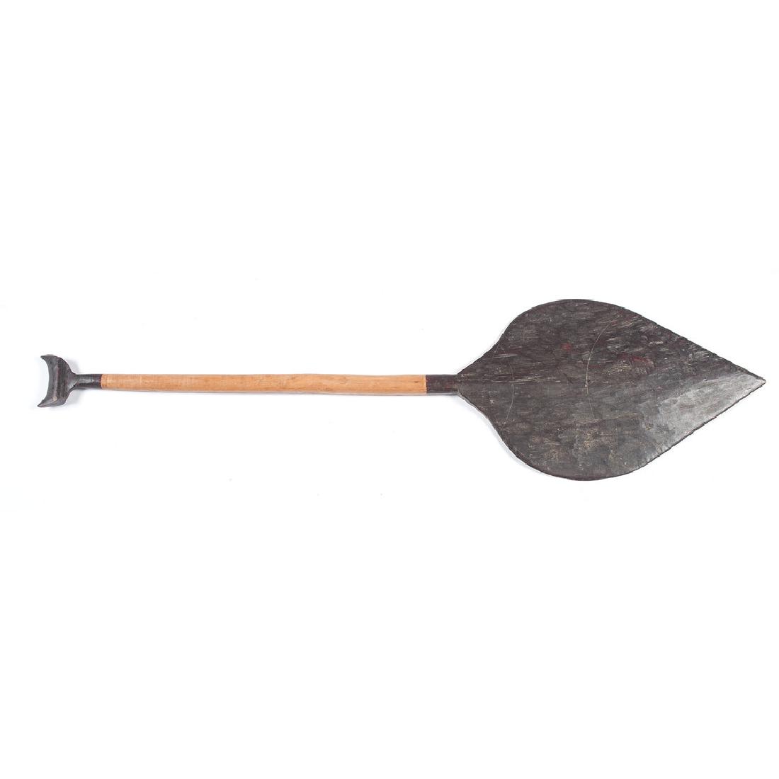 New Guinea, Fiji, and Solomon Island Wood Canoe Paddles: lot of 4, includes a paddle from New Guinea, having narrow and tapered shape with red painted collar, length 61 in.; PLUS one from Fiji, a wider form with carved detail on grip and blade tip covered w