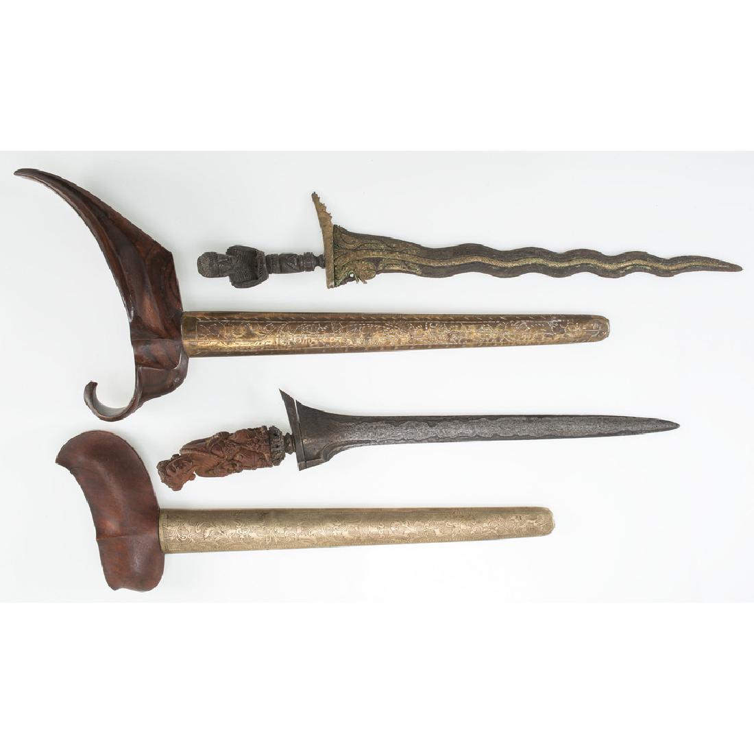 Two Indonesian Kris with Carved Figural Handles: lot of 2, longest 19.75 in. mid-20th century