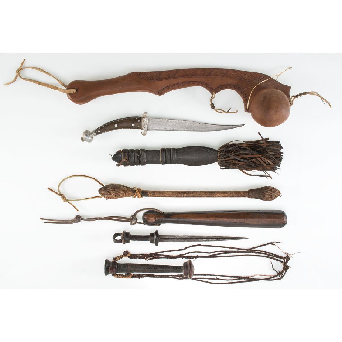 Lot of Four Club Weapons and Daggers: Lot consists of five interesting weapons including three club type weapons made of wood, leather, and rope, the largest measuring 19". Also includes horn and leather-gripped daggers with elaborate lea