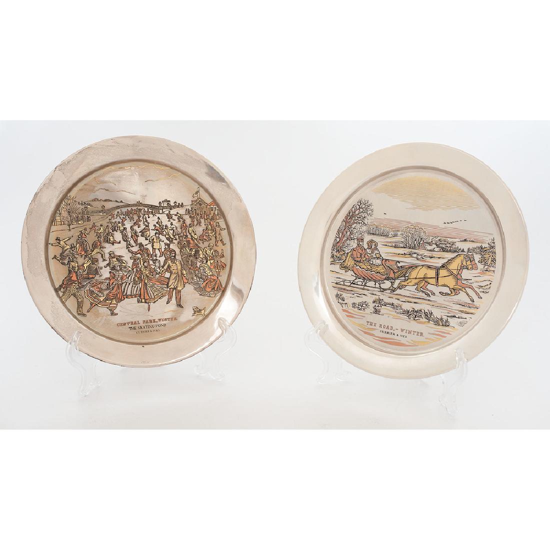 Currier & Ives Sterling Plates: 20th century. Two limited edition sterling plates with copper and gold inlay, by The Danbury Mint, with scenes after Currier & Ives, in original boxes; plate dia. 8 in. (each).