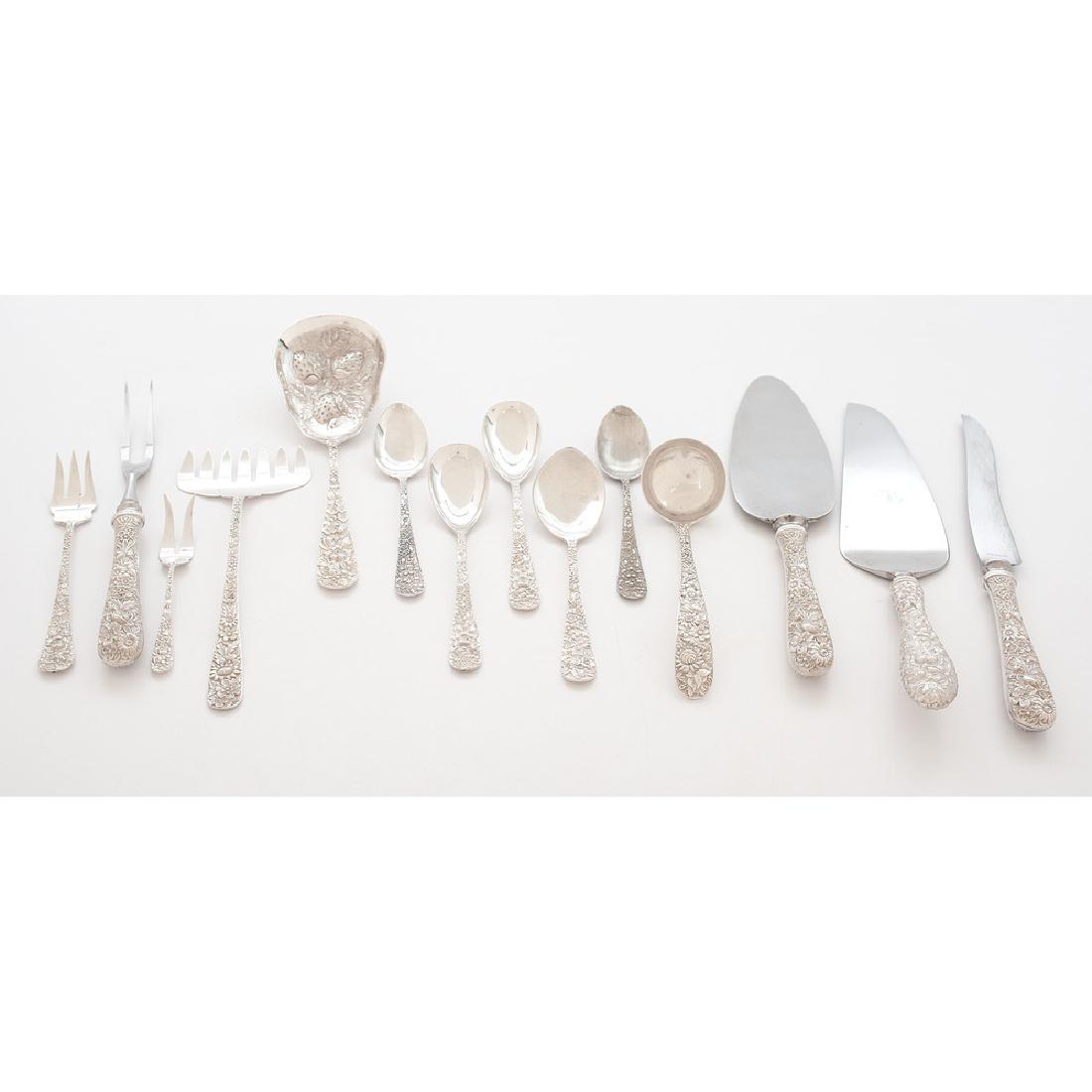 Kirk-Stieff Sterling Serving Pieces: American. A group of floral repoussé sterling serving pieces and teaspoons by Kirk-Stieff including a two-piece steak carving set with stainless blades, a gravy ladle, a sardine fork, and a pastry se