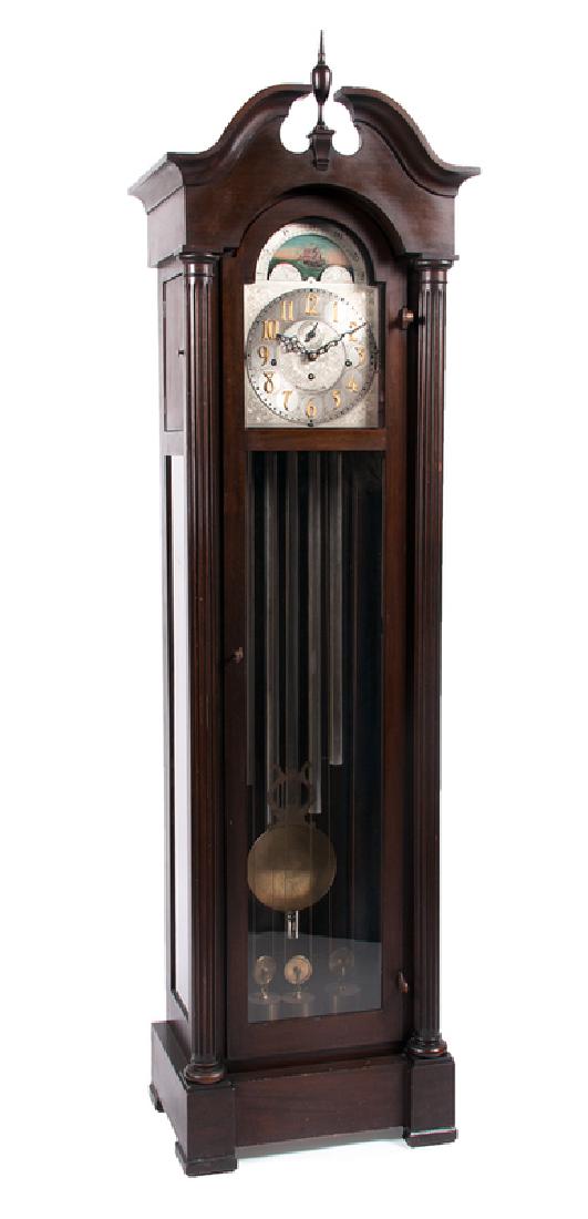 Charles Jacques Six-Tube Case Clock: American, early 20th century. A Charles Jacques case clock in mahogany, having a brass dial and moon dial, with six gongs and eight-day time and strike chimes, the case having a broken arch bonnet wit