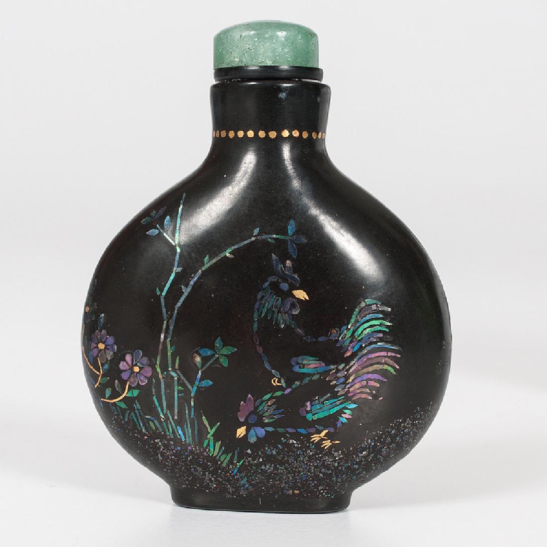 Black Lacquer and Mother-of-Pearl Republic Period Snuff: Chinese. A Republic period black lacquer snuff bottle with jade lid, decorated on both sides with scenes of roosters among foliage in mother-of-pearl and gold foil, Qianli mark on underside; ht. 2.5 i