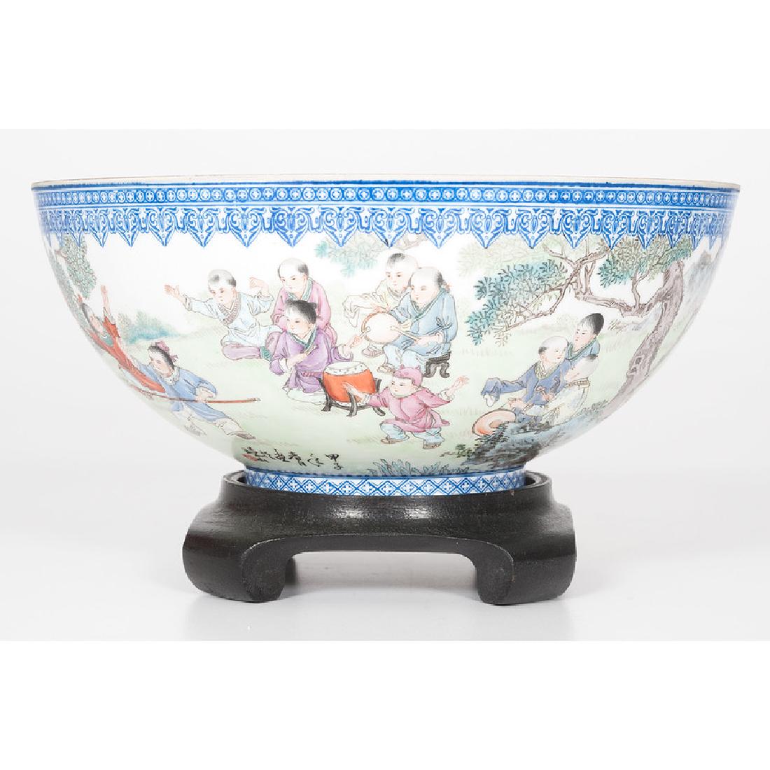 Chinese Eggshell Porcelain Bowl: Chinese, mid-20th century. An eggshell porcelain bowl with painted scene of children playing, with kiln mark on underside, with hardwood stand; bowl ht. 4, dia. 9.25 in. Provenance: 