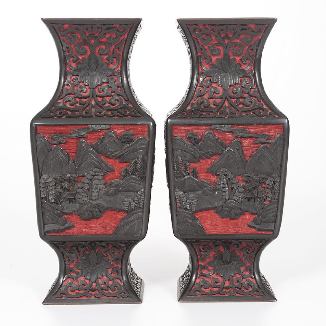 Chinese Cinnabar Vases: Chinese. A pair of black and red cinnabar vases of squared shape, each finely carved with landscape scenes; ht. 9.25 in. (each). Provenance: 