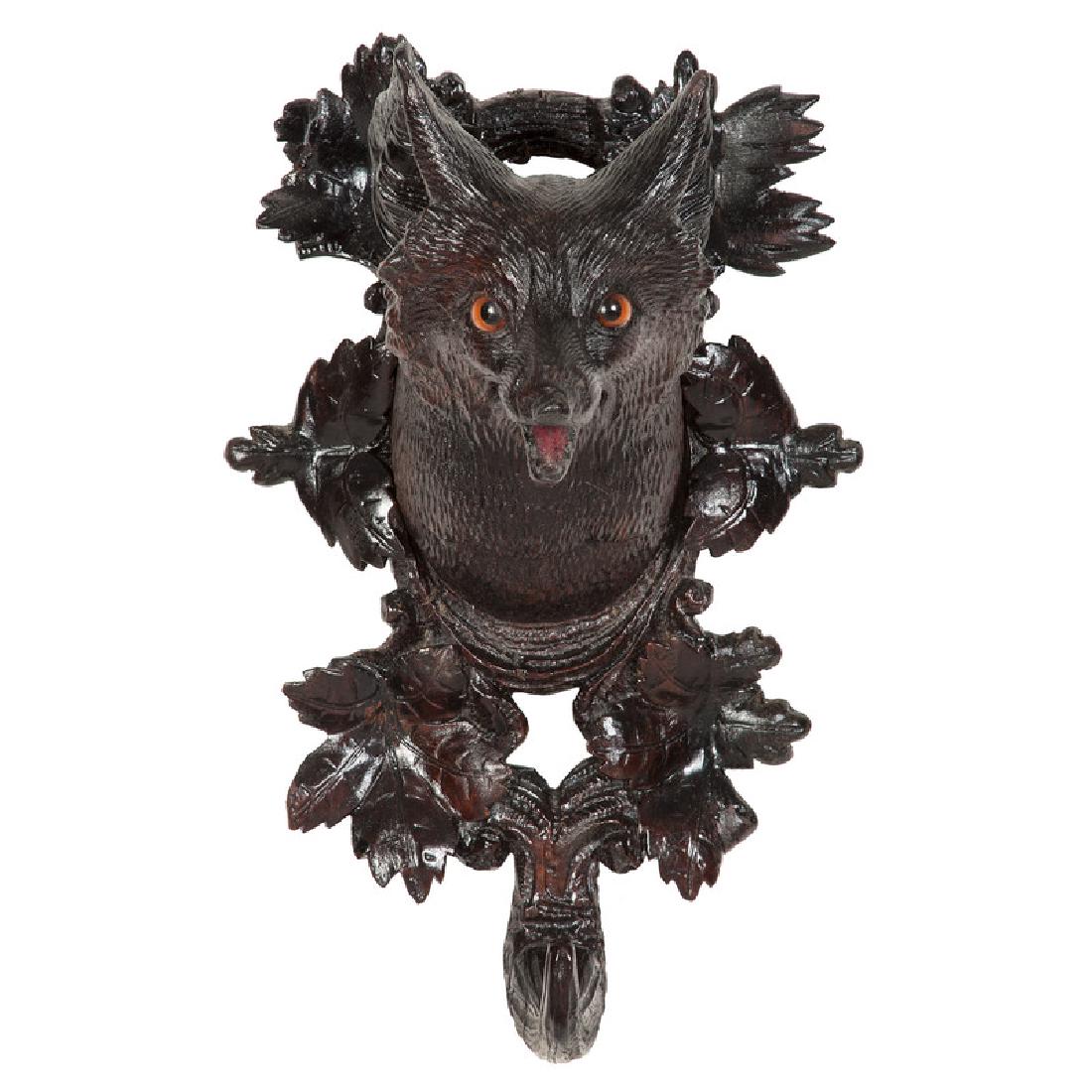 Black Forest Fox Coat Hook: German, late 19th-20th century. A wooden carved coat hook, mimicking antler, decorated with the head of a fox within a wreath of leaves; ht. 10, wd. 6 in.