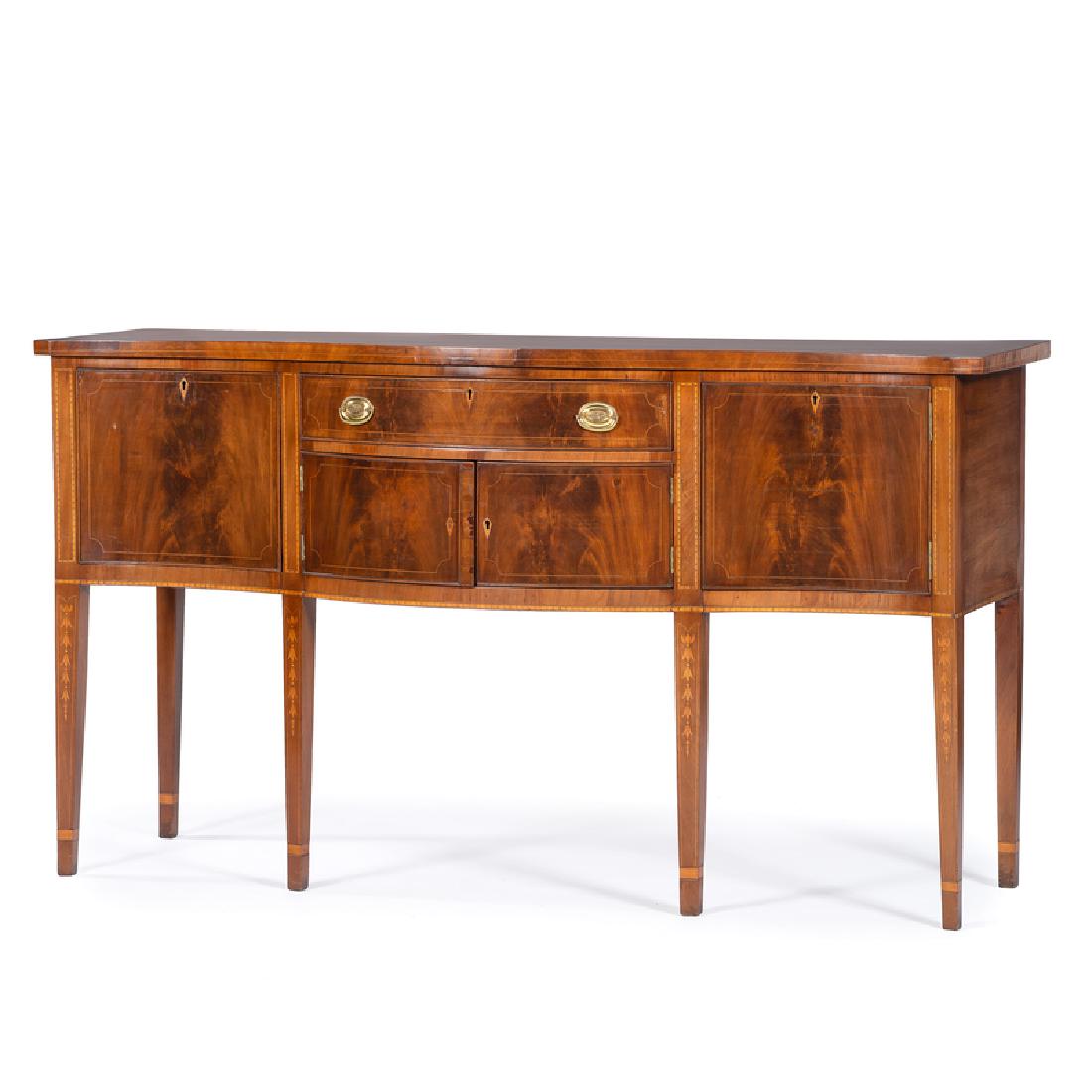 Hepplewhite Serpentine Sideboard: English, 19th century. A Hepplewhite sideboard in mahogany and pine secondary, having a serpentine shaped surface with banding inlaid perimeter, over a conforming case with central cockbeaded and dove