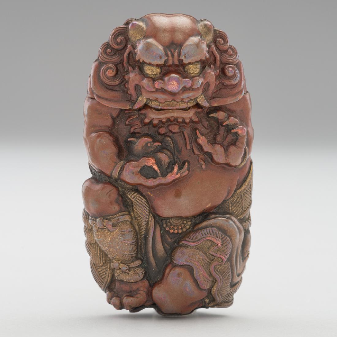 Figural Dragon Repoussé Match Safe: Likely 20th century. A brass and enameled repoussé match safe in the form of an Asian dragon holding a bird, with the dragon's head forming the lid, unmarked; ht. 2.5, wd. 1.5, dp. 0.75 in. Pro