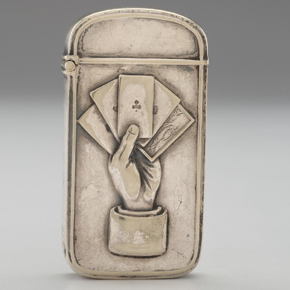 Silverplate Match Safe with Gambling Motifs: American, 20th century. A silverplate match safe with gambling motifs, including articulate scorekeepers to one side, and a dealer's hand grasping playing cards to the reverse, with match strike to un