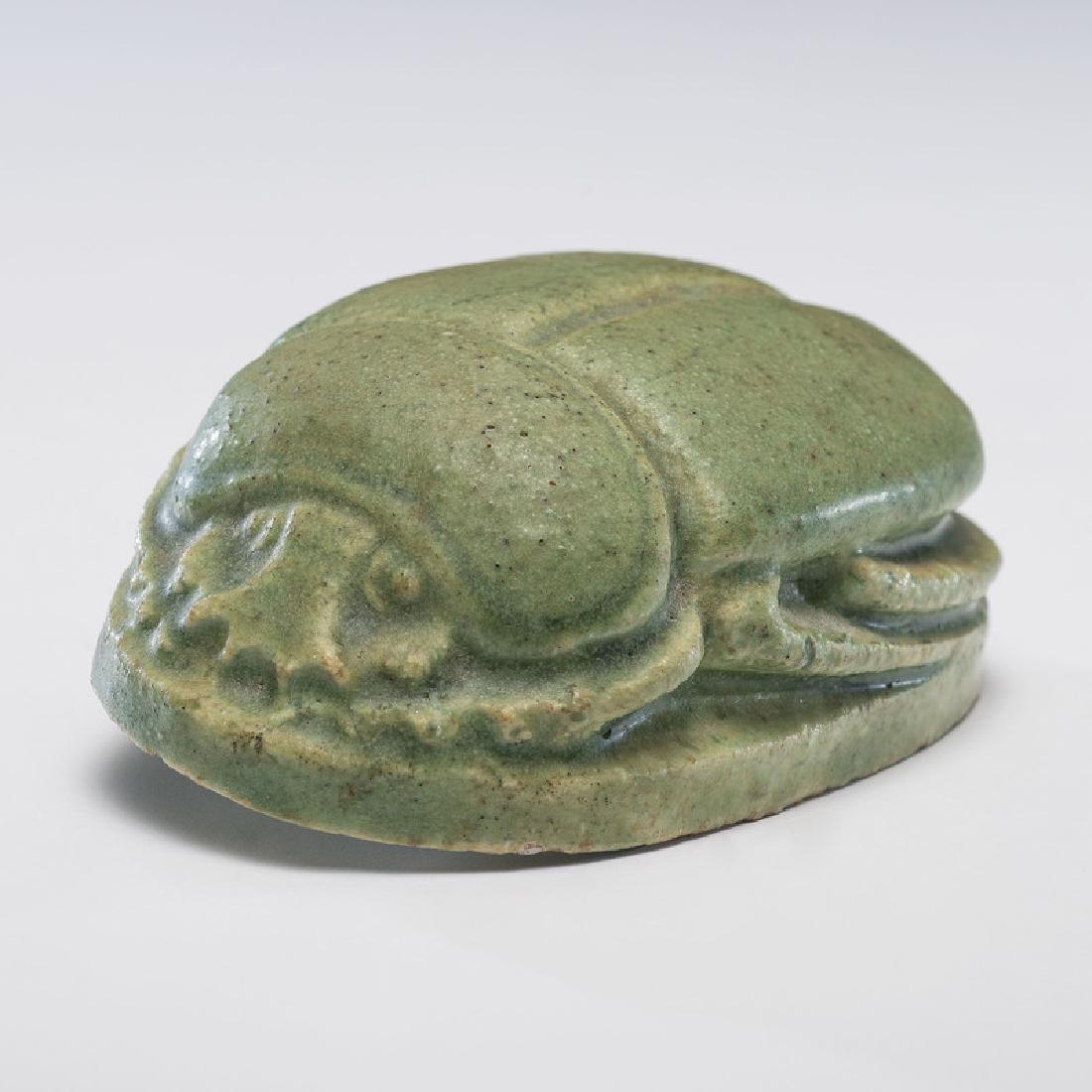 Grueby Faience Company Scarab: American (Massachusetts), early 20th century. A Grueby Faience Company scarab in a matte green glaze, impressed pottery mark on base; lg. 4 in.