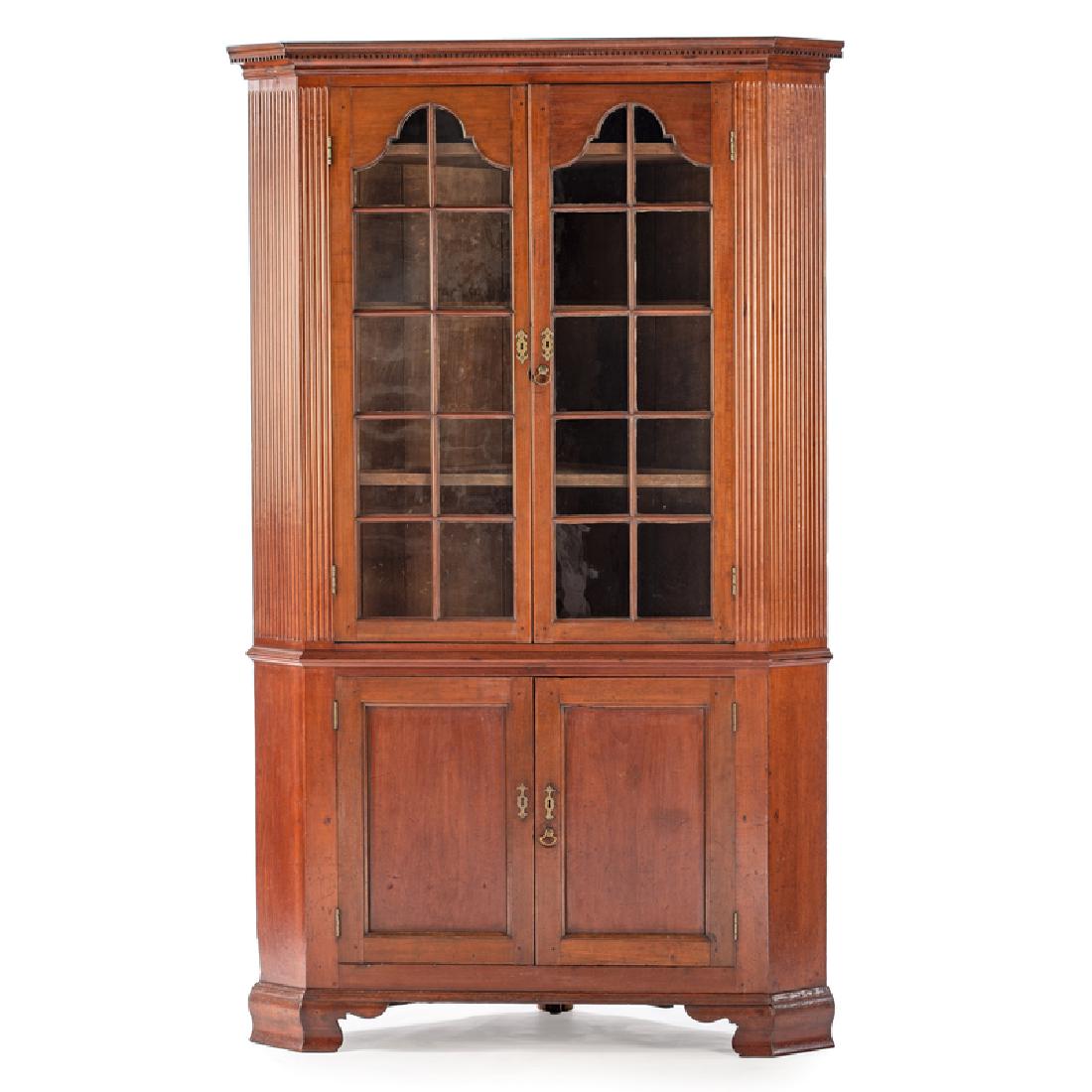Kentucky Queen Anne Corner Cupboard: American (Kentucky), ca 1800. A Queen Anne corner cupboard in cherry, having a dentil molded cornice, over two open arched glass pane doors with straight mullions revealing a three shelf interior, fla