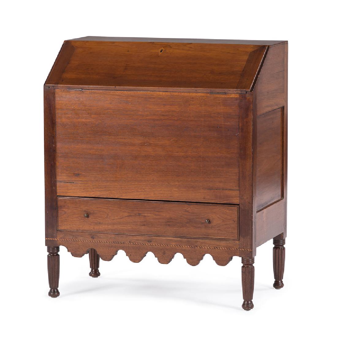 A Fine Sugar Desk in Cherry, Attributed to Kentucky: American (attributed to Kentucky), ca 1800. A very fine sugar desk in cherry, having a slant top writing surface with fitted interior spice drawers and divided compartments, the paneled case having a