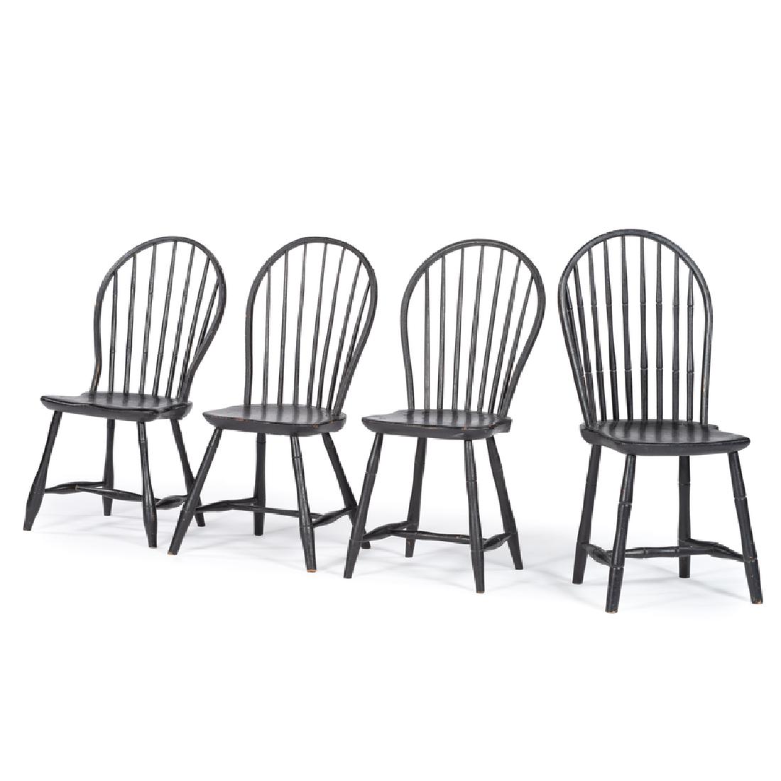Assembled Group of Hoop Back Windsor Chairs: American, late 18th-early 19th century. An assembled group of four hoop back Windsor chairs in black paint, all with shaped hoop backs and spindle supports, over plank seats, rising on bamboo turned l