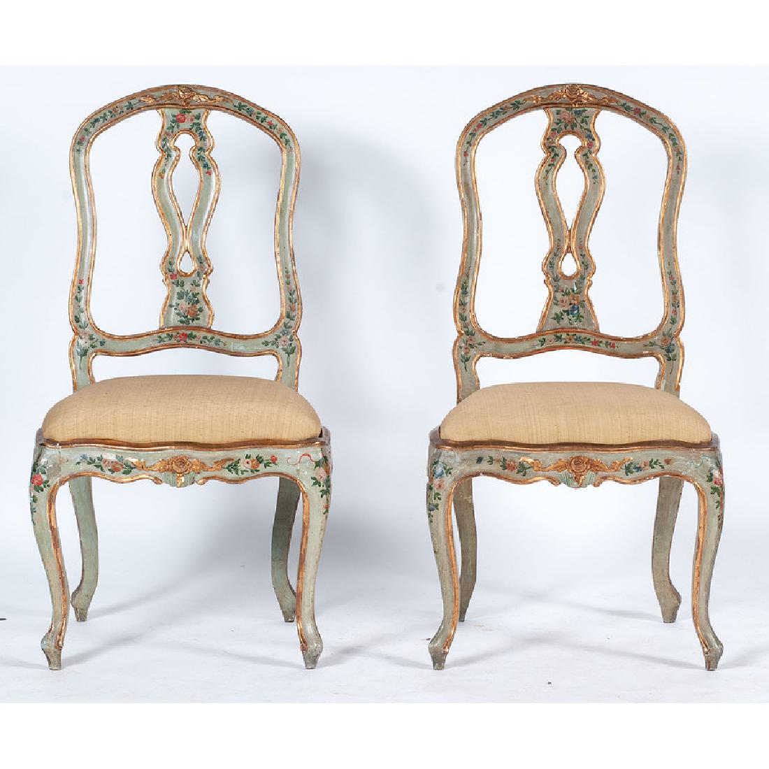Italian Rococo-style Painted Side Chairs: Italian, 19th century. Two gilt and floral paint decorated side chairs, each having a shaped crest with central floral carving, pierced and shaped splat, over upholstered slipper seat with carved