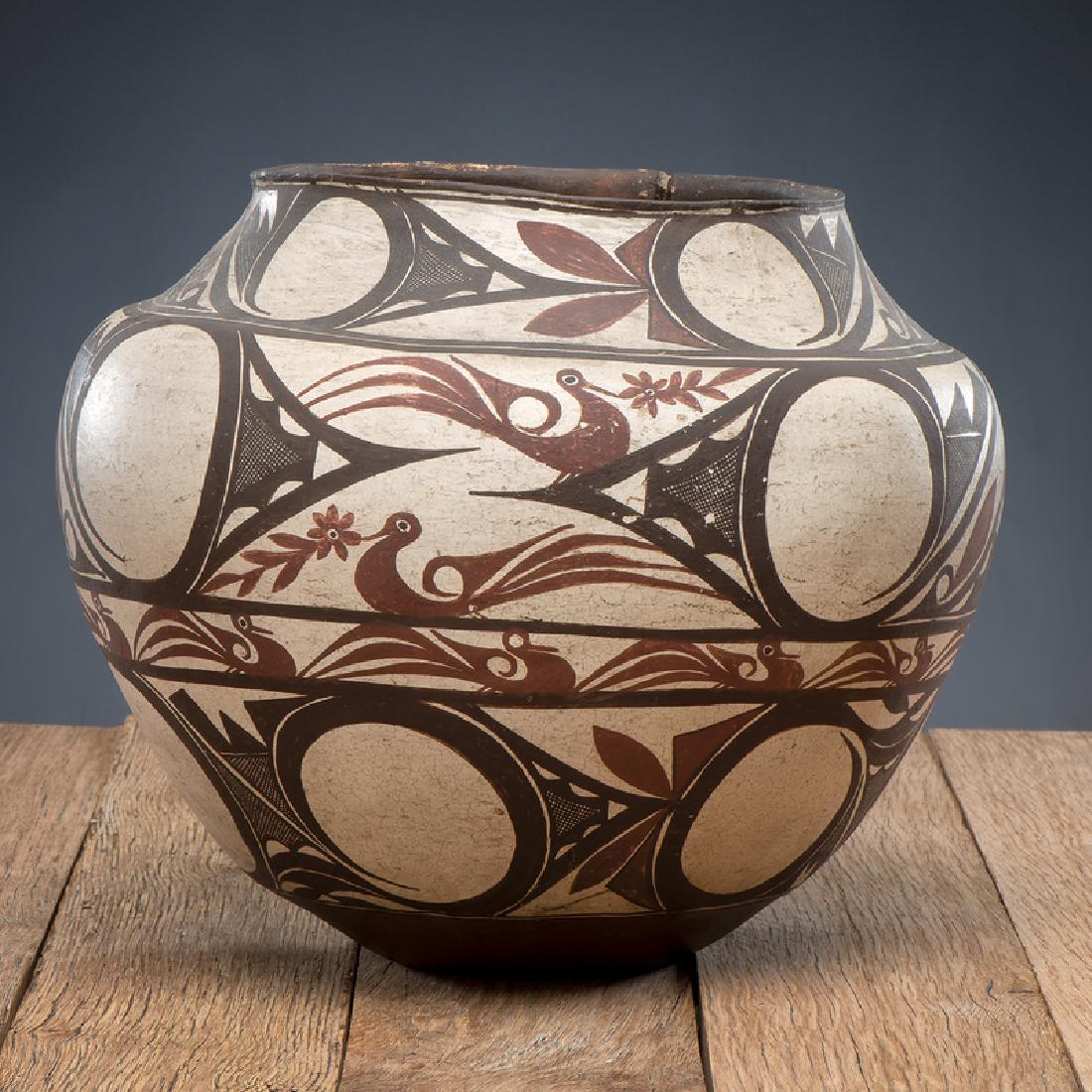 Zuni Polychrome Pottery Olla, From The Harriet and: large form; having a concave base, sharp shoulders, and slightly flared rim; painted boldly with stylized rainbirds, birds with flowers in their beaks, and finely crosshatched winged elements, height