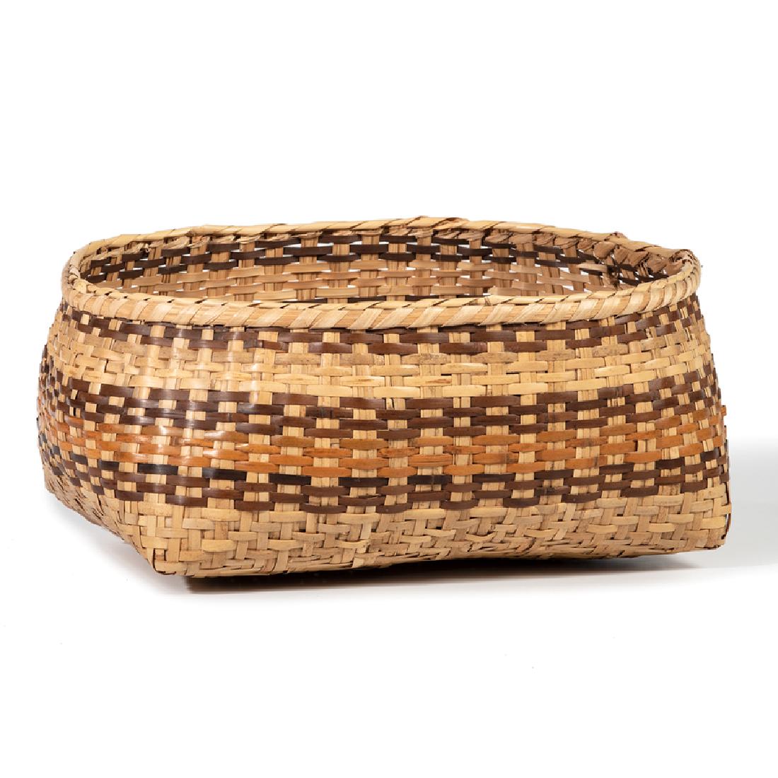 Rowena Bradley (Cherokee, 1922-2003) River Cane Basket: elongated basket having bands dyed with butternut and bloodroot; with U.S. Department of Interior, Indian Arts and Crafts Board tag, height 6 in. x length 14 in. third quarter 20th century