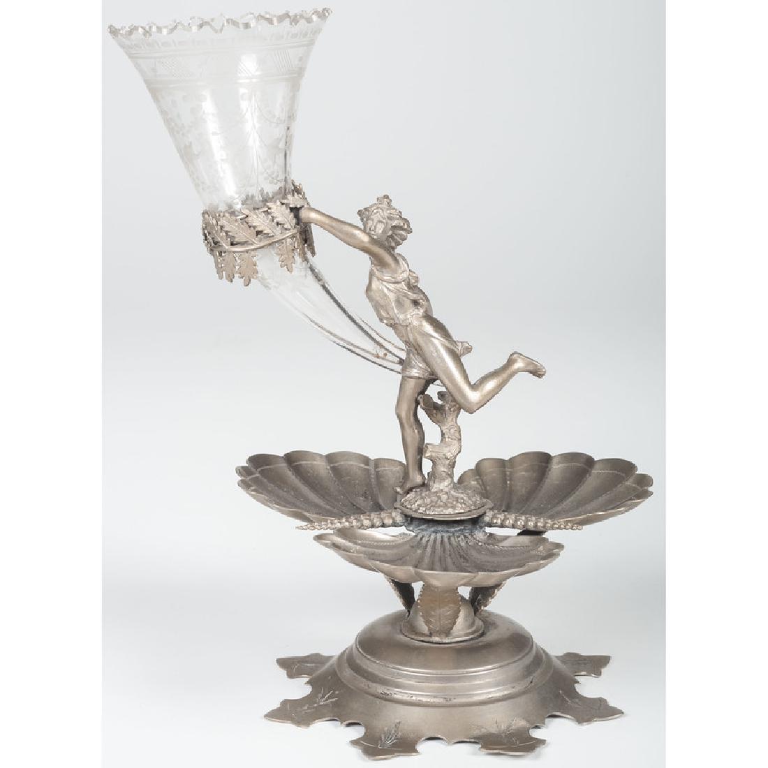 Meriden Silverplate Figural Epergne: American. A silverplated figural epergne by Meriden with etched glass trumpet vase. Marked on underside; oah. 12 in.