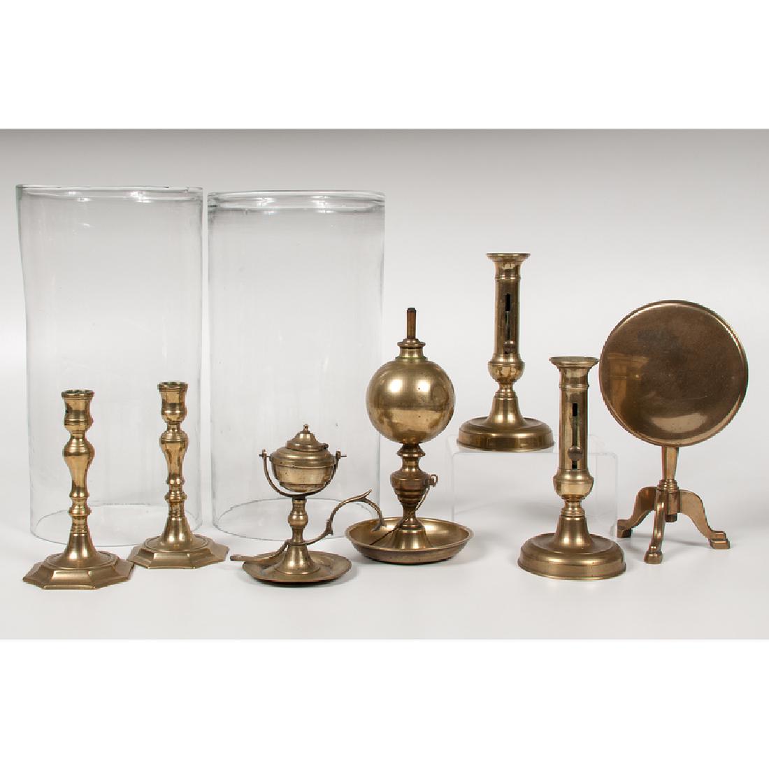 Brass Candlesticks and Lighting, Plus: 19th century. Seven brass lighting pieces, including one ship's whale oil lamp, one globular-form whale oil lamp, a pair of pushup candlesticks, a pair of candlesticks with octagonal bases, and one ti