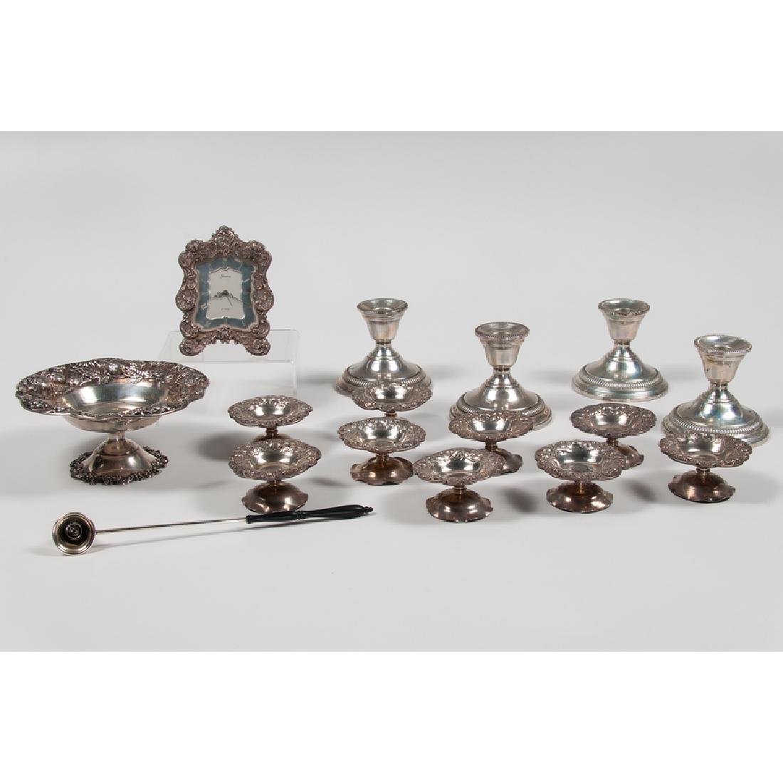 Sterling Dishes and Accessories: American, 20th century. Sixteen sterling dishes and accessories, including one compote and nine pedestal salt dishes in matching strawberry repousse pattern; four weighted candle holders by Tuttle in 