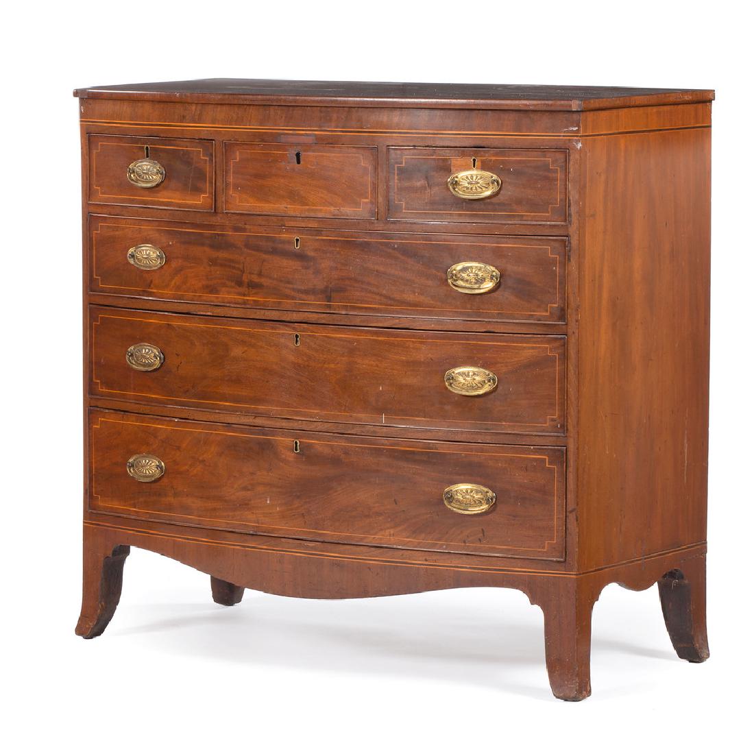 English Hepplewhite Bowfront Chest Of Drawers: English, 19th century. A Hepplewhite bowfront chest of drawers in mahogany, having a bowfront surface, over three aligned and three graduated, cockbeaded and dovetailed drawers with line inlay and bra