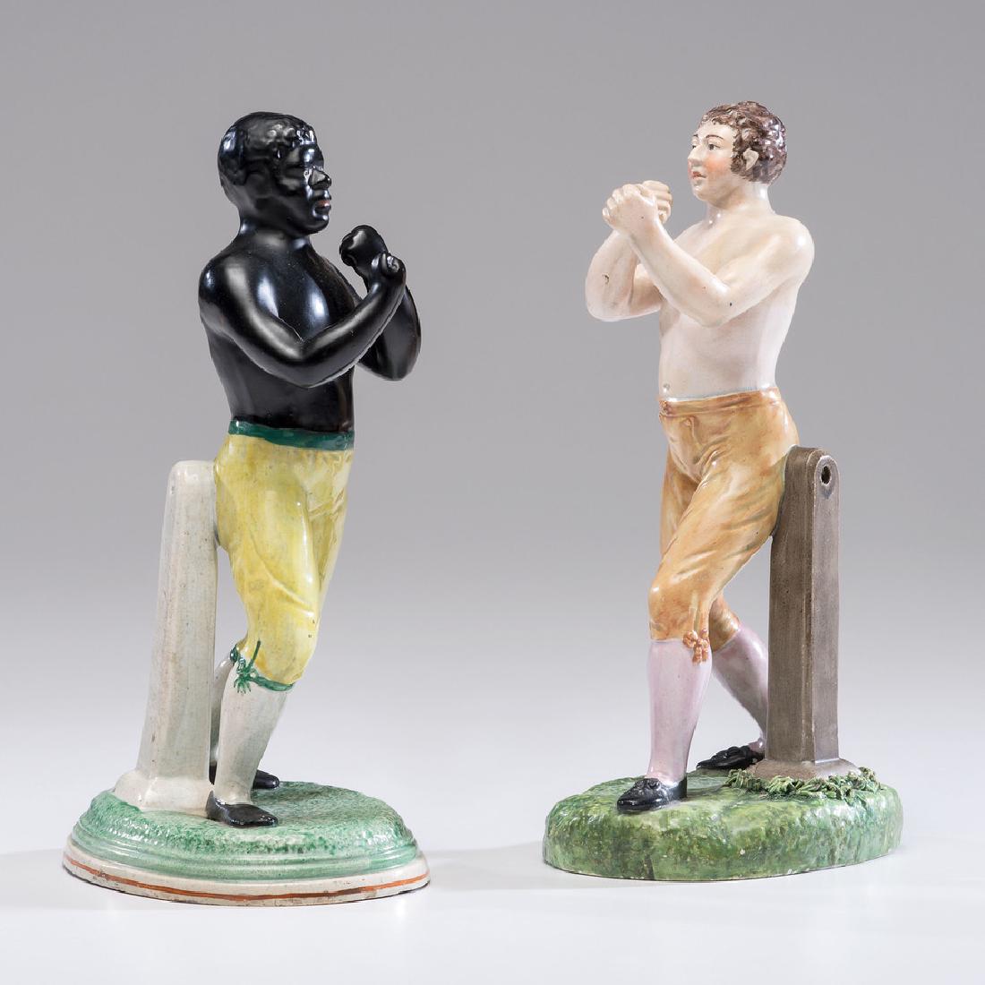 Staffordshire Figures of Tom Cribb and Tom Molyneaux: English, early 19th century. An assembled pair of pearlware figures depicting boxers Tom Cribb and Tom Molyneaux, who famously fought in 1812. Unmarked; ht. 9 in. (each).