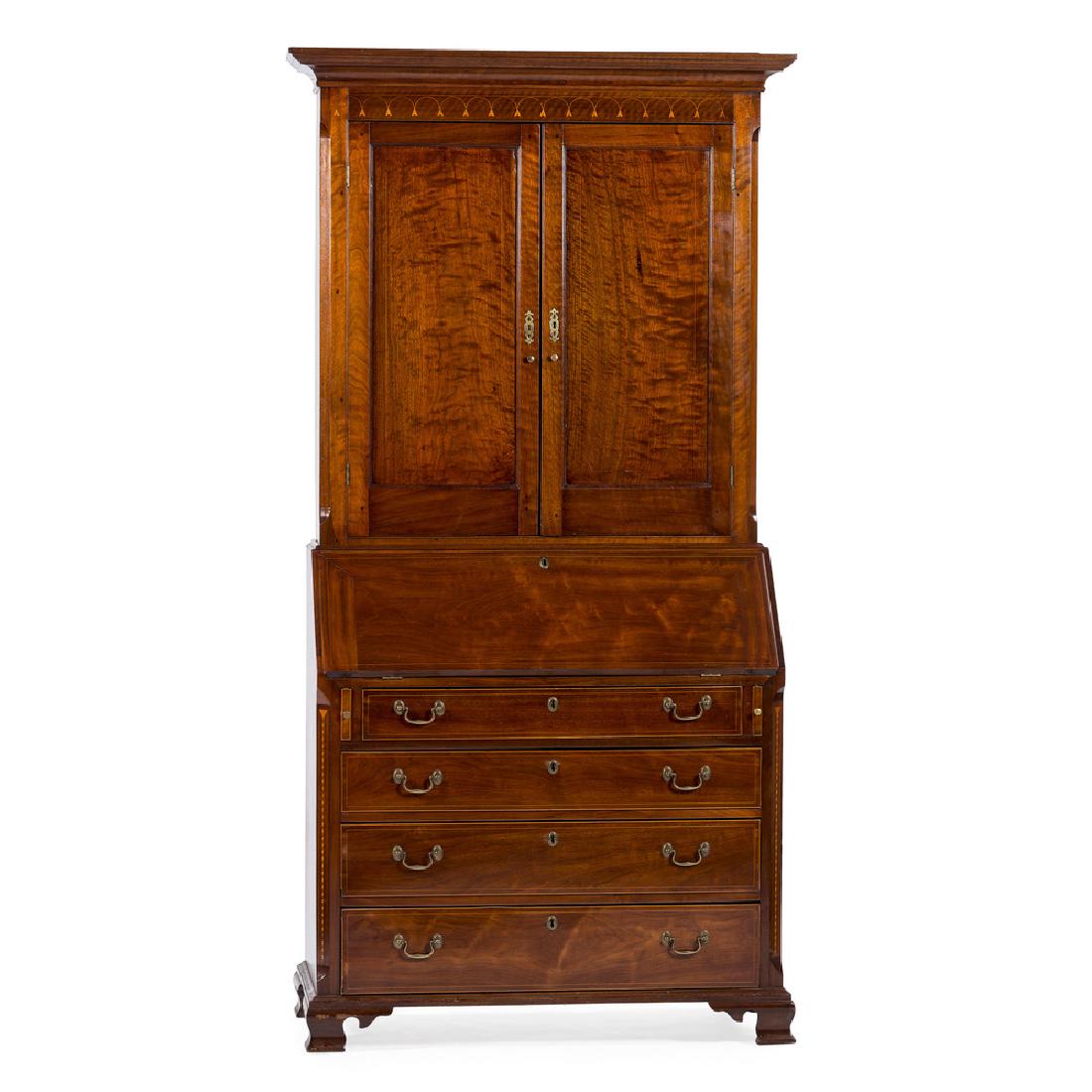 Pennsylvania Walnut Secretary Bookcase: American (Pennsylvania), late 18th-early 19th century. A walnut secretary bookcase in two parts, the upper section with a bold cornice over an inlaid frieze and two paneled doors opening to a shelved 