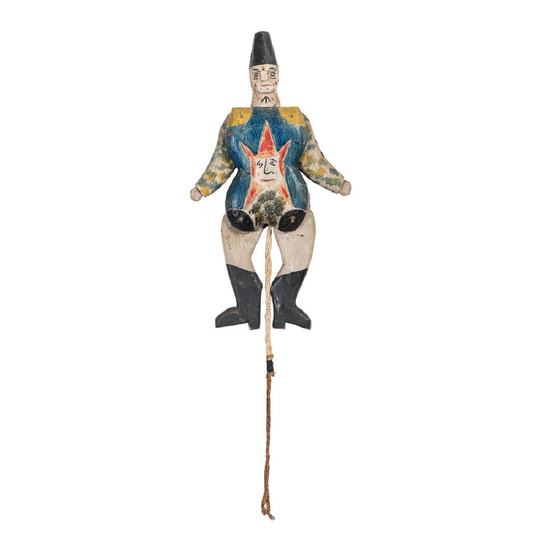Folk Art Harlequin Jumping Jack Toy: Probably American, 19th century. A wooden harlequin jumping jack toy in fine paint decoration; lg. 13.5 in.