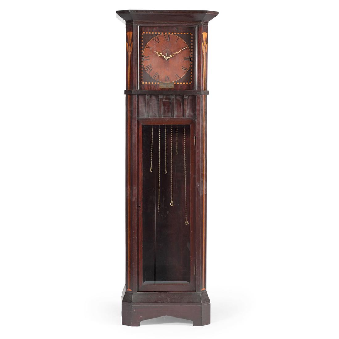 Oscar Onken "Shop of the Crafters" Manchester: American (Cincinnati, Ohio), ca 1910. An Oscar Onken Co. Manchester clock in mahogany, the paneled case having a molded cornice, the whole with canted corners inlaid with fruitwood papyrus motif, fla