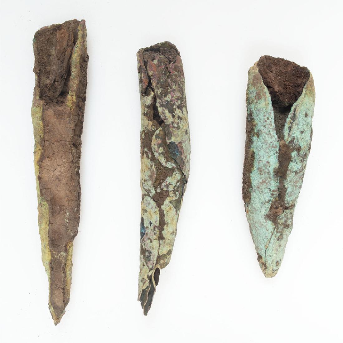 Old Copper Culture Rolled Conical Points: From the Collection of Roger "Buzzy" Mussatti, Michigan Old Copper Culture, 7000-3000 B.C. Houghton County, Michigan lot of 3, longest 2.75 in. Wood is till visible in the sockets.