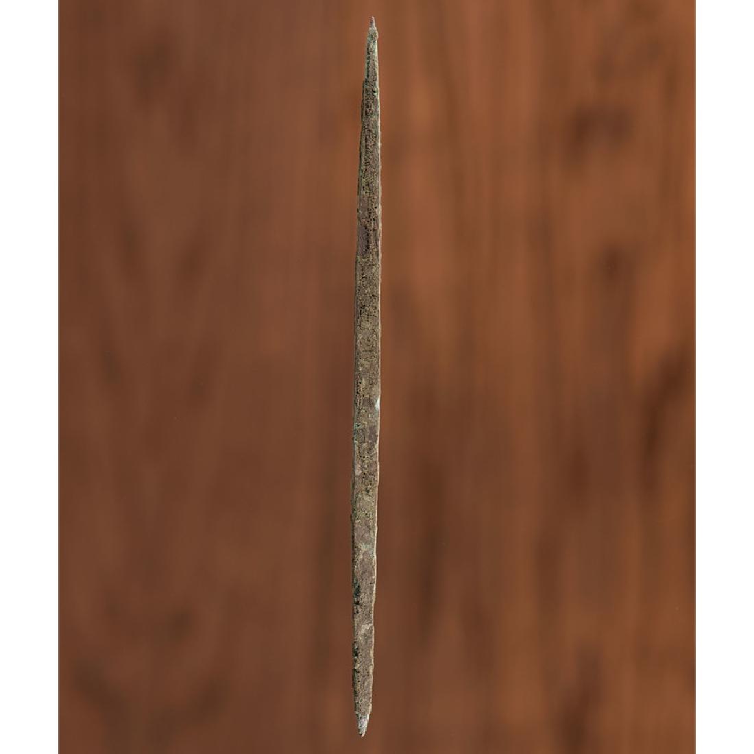 An Old Copper Culture Rectangular Section Awl / Pin: From the Collection of Roger "Buzzy" Mussatti, Michigan Old Copper Culture, 7000-3000 B.C. Vilas County, Wisconsin / Gogebic County, Michigan length 7.5 in. A long, fine, rectangular section awl/pin.