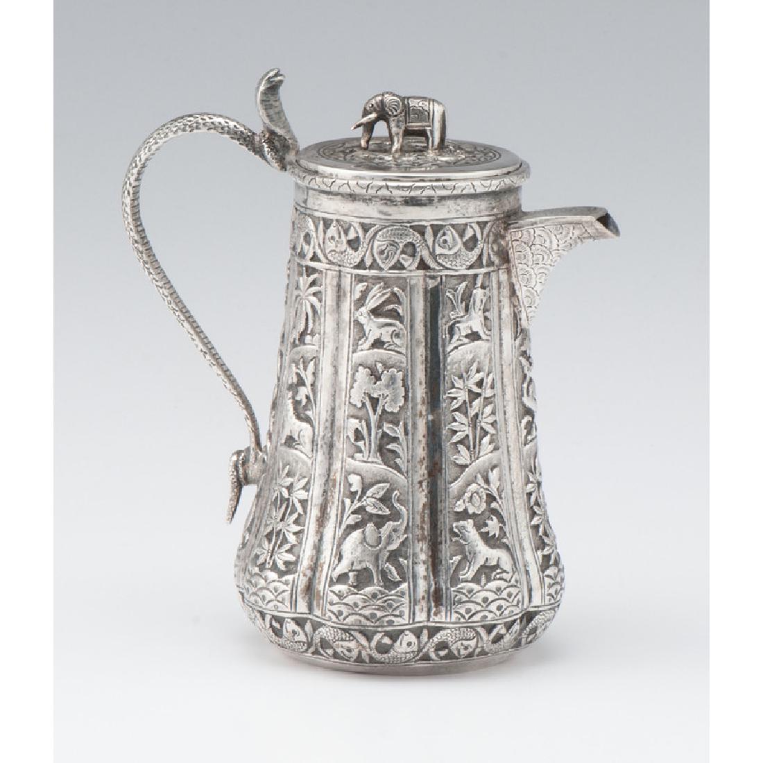 Indian Silver Coffee Pot: Indian Silver Coffee Pot Possibly Lucknow, late 19th-early 20th century. A silver coffee pot having a lobed body decorated with a jungle motif and fish border, with a cobra-form handle and elephant fi