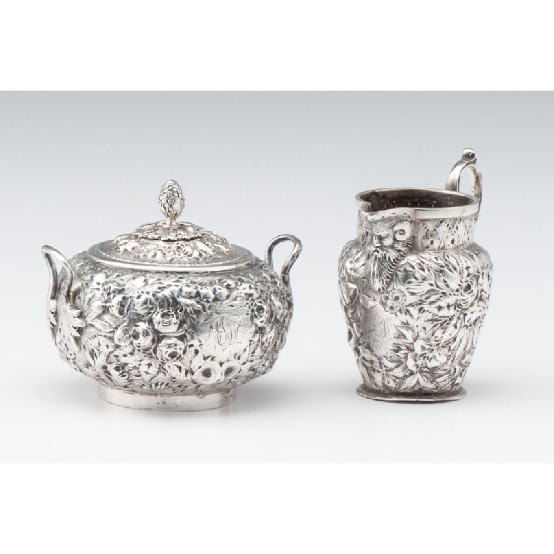 A.E. Warner Jr. Coin Silver Creamer and Sugar Bowl: A.E. Warner Jr. Coin Silver Creamer and Sugar Bowl American, ca 1870-90. A coin silver creamer and lidded sugar, each with Baltimore-style floral repoussé decoration. Both marked Warner / 11-2