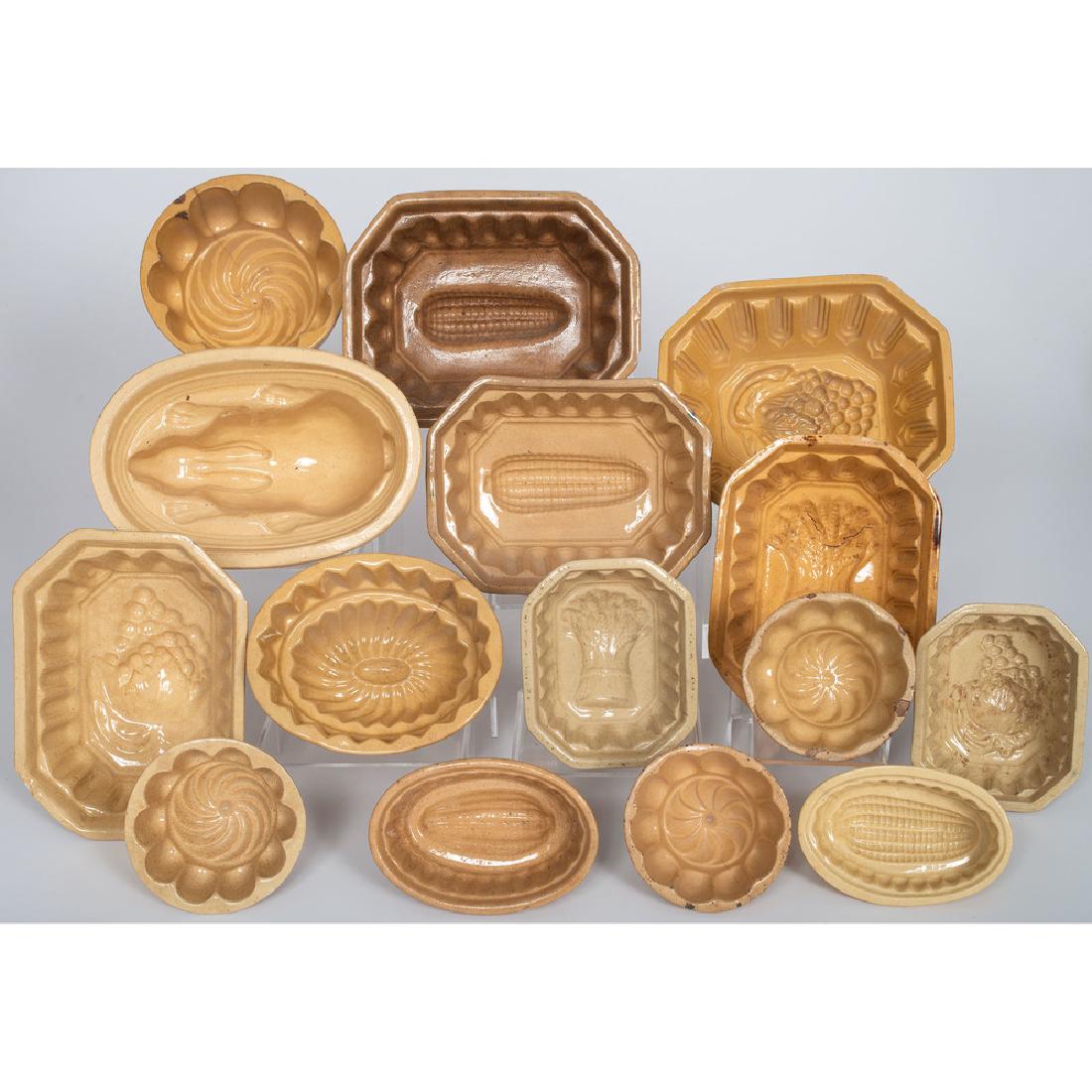 Yellowware Molds: American, 19th century. A group of fifteen yellowware molds, designs including corn cobs, grapes, sheaths of wheat and a rabbit; largest ht. 3.5, lg. 8.25, wd. 7 in. Provenance: Property from the Amer